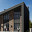 Modern residential exterior with dark cladding